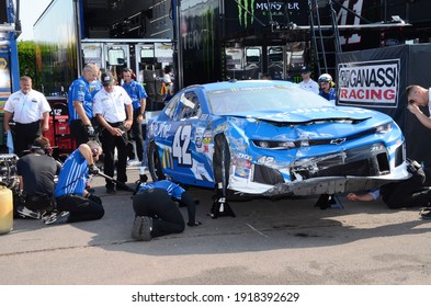 Long Pond, PA, USA - July 27, 2019:  Mechanics scramble to fix NASCAR driver Kyle Larson's crashed car following practice for the 2019 NASCAR Gander RV 400 at Pocono Raceway in Pennsylvania.