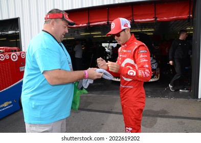 Long Pond, PA, USA - July 29, 2017:  NASCAR driver Kyle Larson signs an autograph following practice for the 2017 Overton's 400 at Pocono Raceway in Pennsylvania.