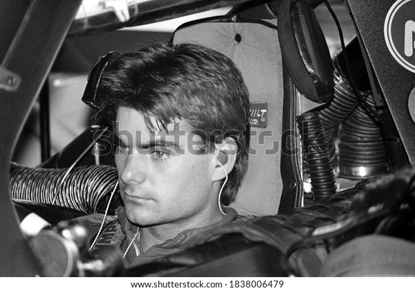 Long Pond, PA /\
USA - July 17, 1994: A vintage, old-school black-and-white photo of\
NASCAR stock car driver Jeff Gordon in his car at Pocono Raceway in\
Pennsylvania.