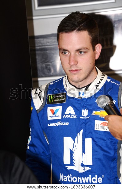 Long Pond, PA, USA - July\
27, 2019:  NASCAR driver Alex Bowman gets interviewed after\
qualifying for the 2019 NASCAR Gander RV 400 at Pocono Raceway in\
Pennsylvania.