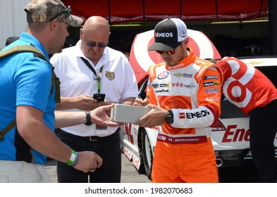 Long Pond, PA, USA - June 10, 2017:  NASCAR driver Kyle Larson signs an autograph following practice for the 2017 Axalta 400 at Pocono Raceway in Pennsylvania.