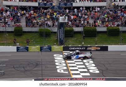 Long Pond, PA, USA - June 26, 2021:  John Hunter Nemechek Speeds Under The Checkered Flag To Win The 2021 CRC Brakleen 150 NASCAR Camping World Truck Series Race At Pocono Raceway In Pennsylvania.