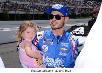 Long Pond, PA, USA - June 26, 2021:  NASCAR driver Kyle Larson and his daughter await the start of the 2021 NASCAR Pocono Organics CBD 325 at Pocono Raceway in Pennsylvania.