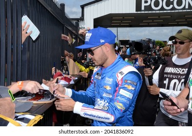 Long Pond, PA, USA - June 26, 2021:  NASCAR driver Kyle Larson signs autographs before the start of the 2021 NASCAR Pocono Organics CBD 325 at Pocono Raceway in Pennsylvania.