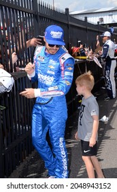 Long Pond, PA, USA - June 27, 2021:  NASCAR driver Kyle Larson watches his son while signing autographs before the 2021 NASCAR Explore the Pocono Mountains 350 Cup Series race in Pennsylvania.