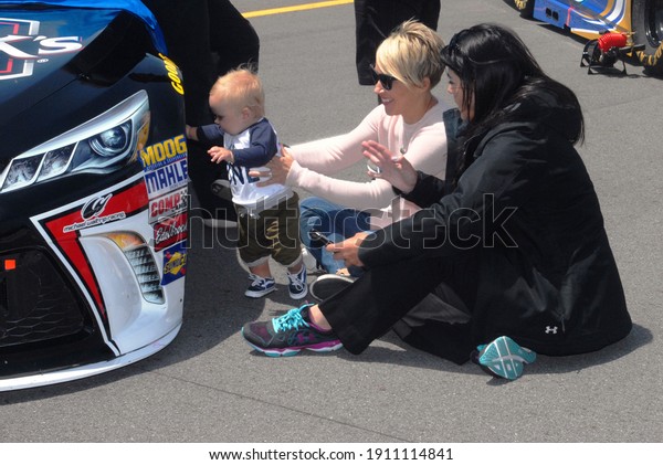 Long Pond, PA, USA - June 7, 2015:  NASCAR\
driver Clint Bowyer\'s littlest fan checks out his car before the\
start of the 2015 NASCAR Axalta We Paint Winners 400 at Pocono\
Raceway in Pennsylvania.
