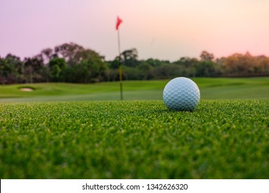 A long putt on the  green as sunset closes in - Shutterstock ID 1342626320