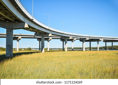 Long raised concrete bridge crossing marsh