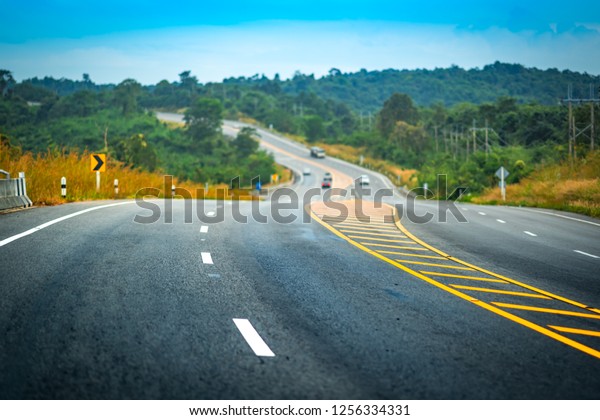 Long road and blue sky on day time. Beautiful\
atmosphere overlook azure cloud mountain beautiful sunset. Like\
living on journey. It is obstacles to overcome dream and hope in\
life to fight to victory