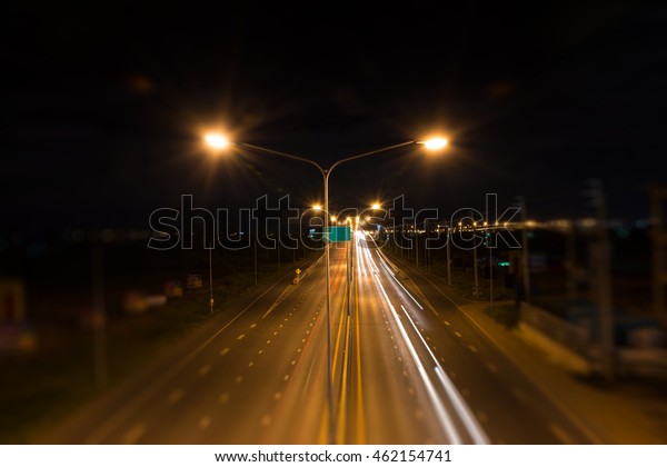 long road at dark\
night motion blurred side.