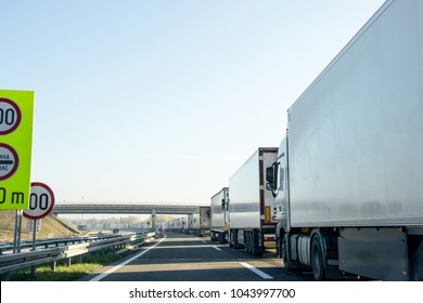 A Long Row Of Cargo Trucks Waiting In Queue To The Customs Between Serbia And European Union