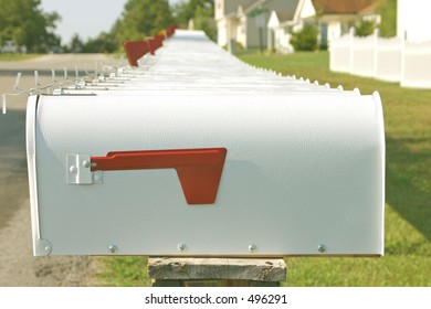 A long row of mailboxes, all exactly alike on a quiet street in America
