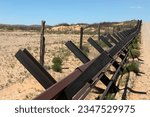 A long row of Normandy-style vehicle barriers lies south of a U.S. Border Patrol surveillance road near Columbus, New Mexico, on April 11. 