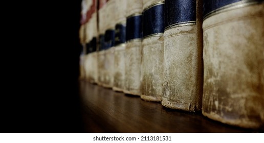 Long row of old leather law books on a shelf for learning and study