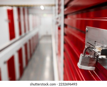 Long row of red color doors of self storage facility. Service to keep safe extra belongings. Nobody. Selective focus. Clean and well run business. - Shutterstock ID 2232696493