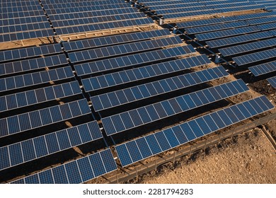 Long rows of photovoltaic panels at solar farm for converting energy of sun to electricity in concept of renewable energy and natural resources. Aerial view - Shutterstock ID 2281794283