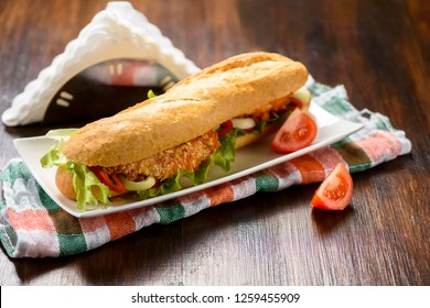 Long Sandwich With Breaded Chicken Tenderloin And Vegetables