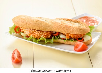 Long Sandwich With Breaded Chicken Tenderloin And Vegetables