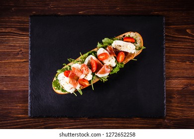 Long Sandwich On Black Stone Plate