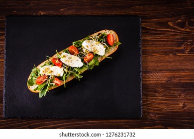 Long Sandwich On Black Stone Plate