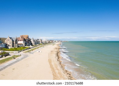 The long sandy beach of Sword beach in Lion-sur-Mer in Europe, France, Normandy, towards Ouistreham, in summer, on a sunny day.