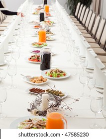 Long Served Restaurant Table With Snacks And Salads