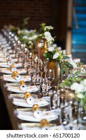 Long Set Dinner Table With Party Poppers, Wine Glasses, And Flowers. Selective Focus.