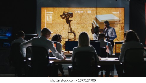 Long Shot Of Mars Mission Leader Giving Briefing In Control Room