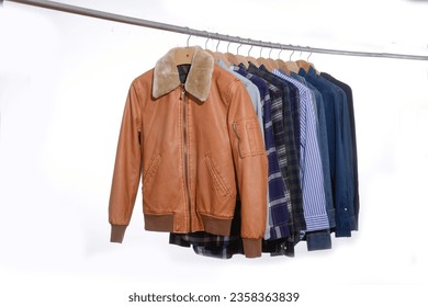 long sleeved ,striped ,shirt,brown jacket jeans jacket, plaid on hanger - Powered by Shutterstock