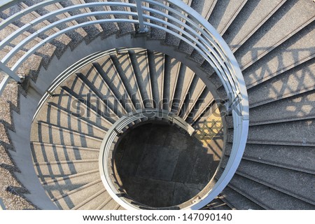 long spiral stair of footbridge with the sun ray light and shadow in daytime detail , in Central, hong kong