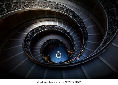 Long spiral, winding stairs. Dark shadows, mysterious mood with single soft light. - Powered by Shutterstock