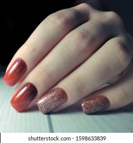 Long square nails covered and gel Polish and gradient design wooden background  Red gradient the nails  From black to red  Brilliant design 