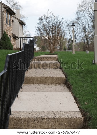 The long steps by the railing eventually reach the bottom.