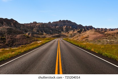 long straight road ahead in Badlands National Park, South Dakota,