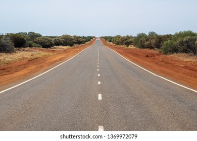 Long Straight Road Leading Through The Dry Australian Bush Land