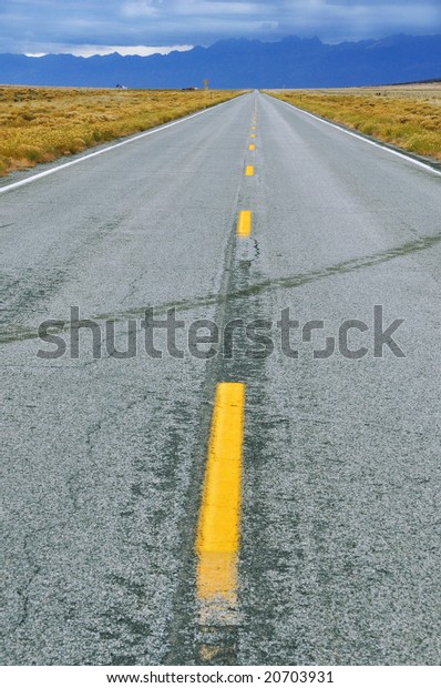 Long straight road to\
mountains