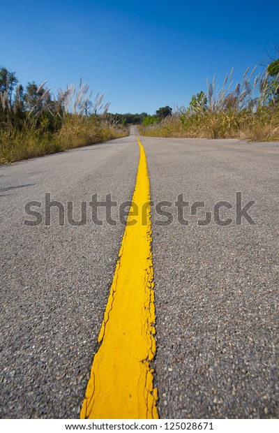 long street, yellow street line dividing road\
to countryside