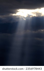 Long sunrays shining above mountains in storm clouds sun rays - Shutterstock ID 2356978443