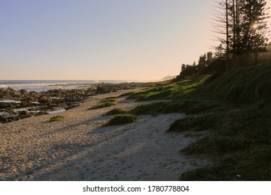 long sunset shadows on an empty beach