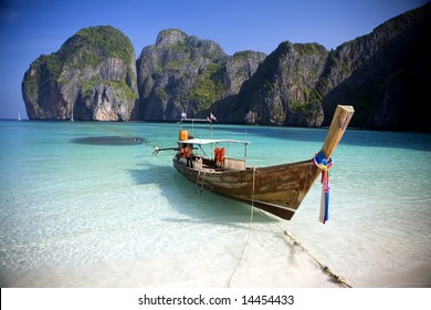 A long tail boat sits in Maya Bay, Koh Phi Phi Ley, Thailand.