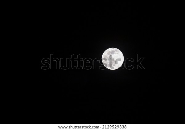 Long\
telephoto lens shot of the moon in a black\
sky.
