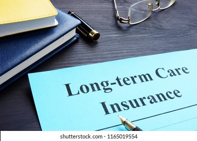 Long Term Care Insurance Policy On A Table.