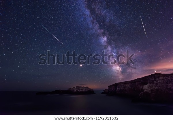 Long time exposure night landscape with planet\
Mars and Milky Way Galaxy during the Perseids flow above the Black\
sea, Bulgaria