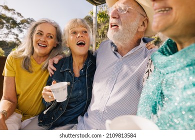 Long Time Friends Having Fun Together Over Morning Tea. Cheerful Elderly People Enjoying Their Summer Vacation At A Spa Resort. Happy Senior Citizens Enjoying Themselves After Retirement.