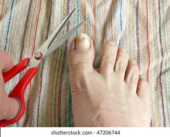 Long Toe Nails And Hand With Scissors