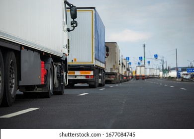 a long traffic jam of many trucks at the border , a long wait for customs checks between States due to the coronavirus epidemic, increased sanitary inspection of cargo transport - Shutterstock ID 1677084745