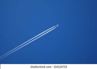 A Long Trail Of Jet Plane On Blue Sky