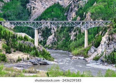 Long  train bridge extends over river in the remote mountain area of Alaska. - Powered by Shutterstock