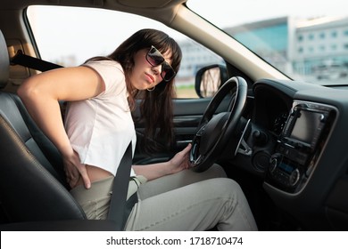 Long Travel Tiredness. Woman Touching Her Waist Because She Tired To Drive Her Car For A Long Time. Uncomfortable Driver Seat