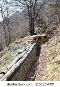 Long Trench Dug Into The Rock By Army Soldiers During The War With Sandbags For Defense